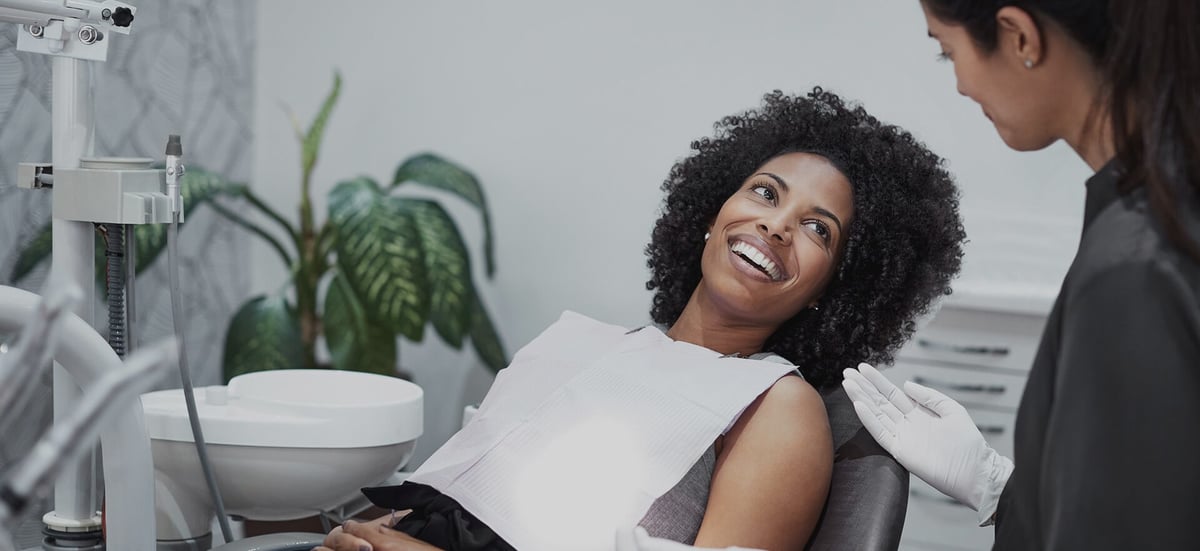 Dentist conversing with patient