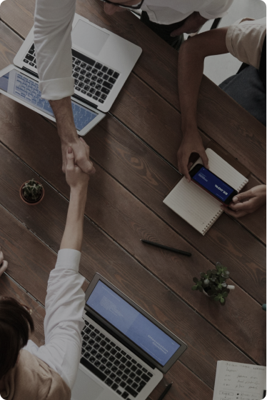 Closeup of two 8 West Consulting colleagues doing a handshake.