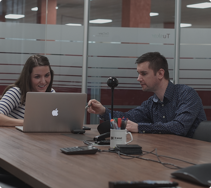Picture of two 8 West Consulting teammates sharing information and discussing about their project.