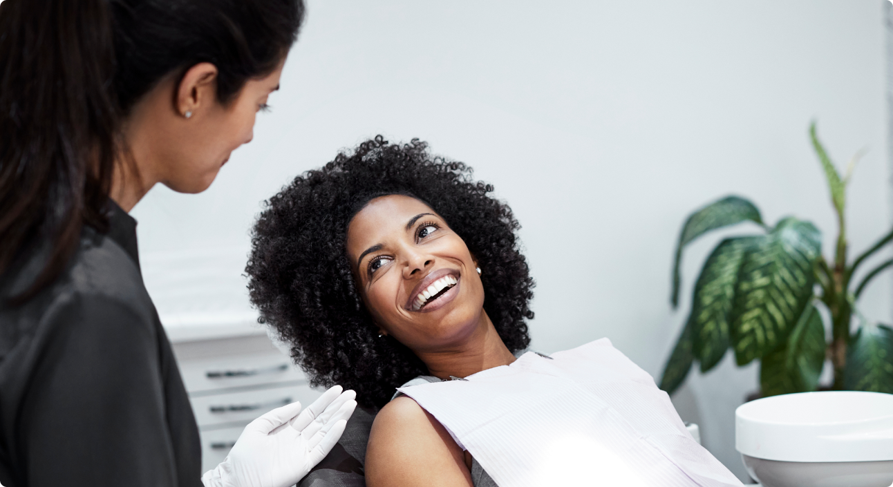 8 West Consulting website image of a patient smiling with the dentist.