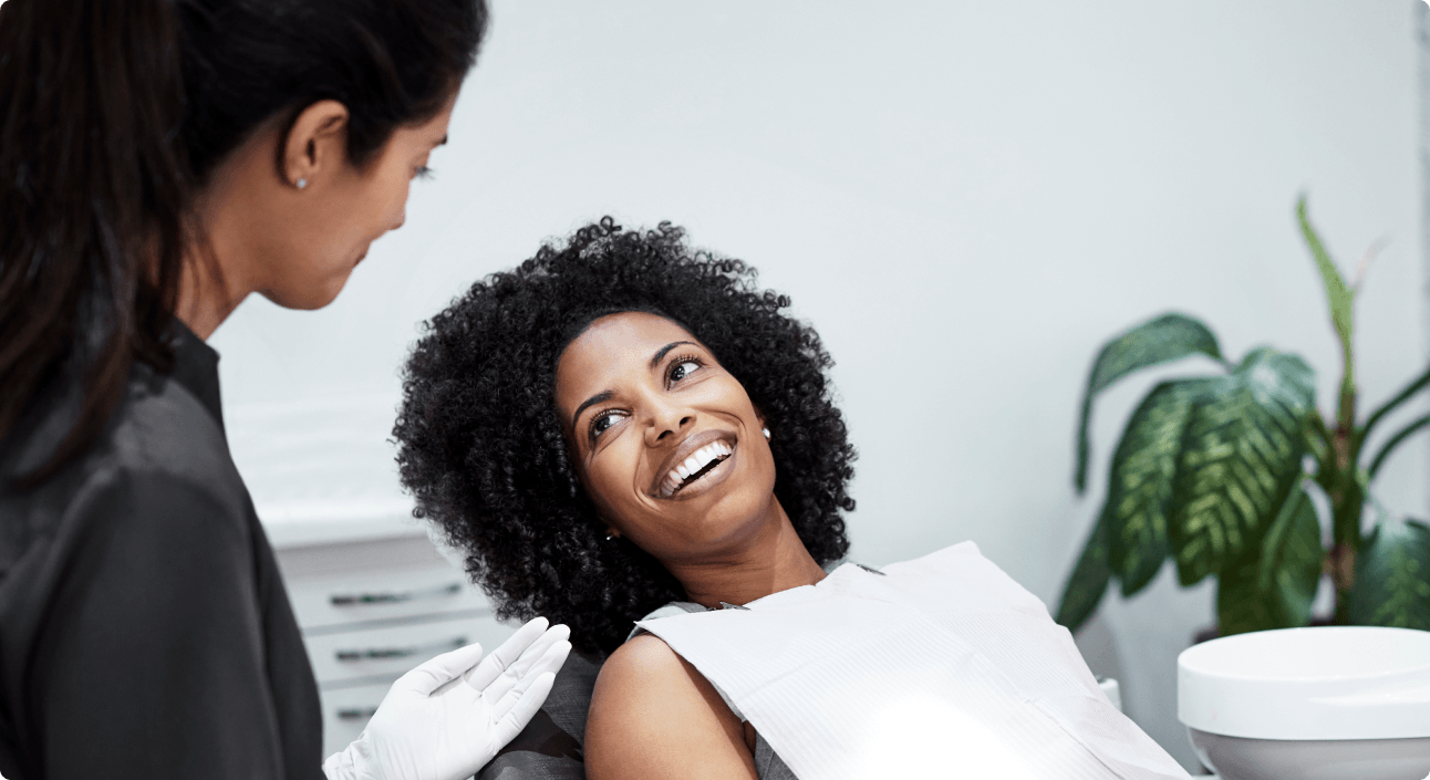 8 West Consulting website image of a patient smiling with the dentist.